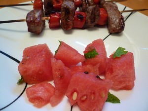 Minted Watermelon Salad Served as a Side with Spicy Beef Kebabs with Lime