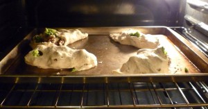 Calzones (with the ripped and torn) baking.