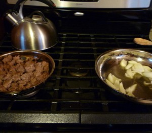 Finishing cooking up the sausage and starting the onions and oil