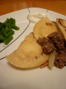 Pierogies and Crumbled Sausage with sour cream and green beans