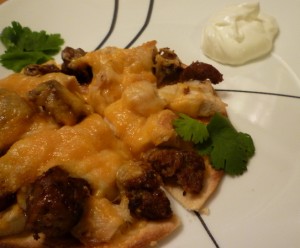 Chicken and Chorizo Tostada with sour cream and cilantro