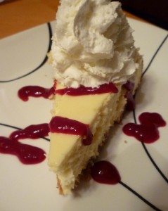 Cheesecake Supreme with Raspberry Sauce and Whipped Cream