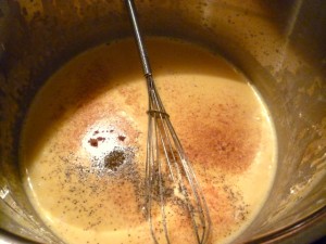 Whisking the pepper into the creamy cheese sauce.